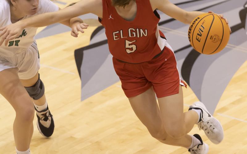 Senior Lizzie Peak (5) dribbles toward the basket during the McGuinness game last week. Elgin won the consolation championship title 51-39 at the Weatherford Classic. HUGH SCOTT JR. | SOUTHWEST CHRONICLE