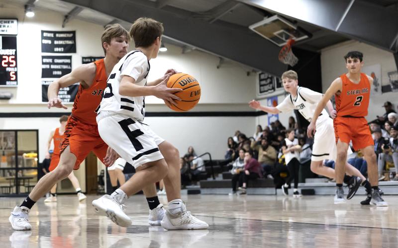 Sterling’s Nate Anderson (0) and teammate Max Puccio (2) press Fletcher in the backcourt during Tuesday’s game. The defensive pressure created several turnovers for Sterling. HUGH SCOTT JR. | SOUTHWEST CHRONICLE