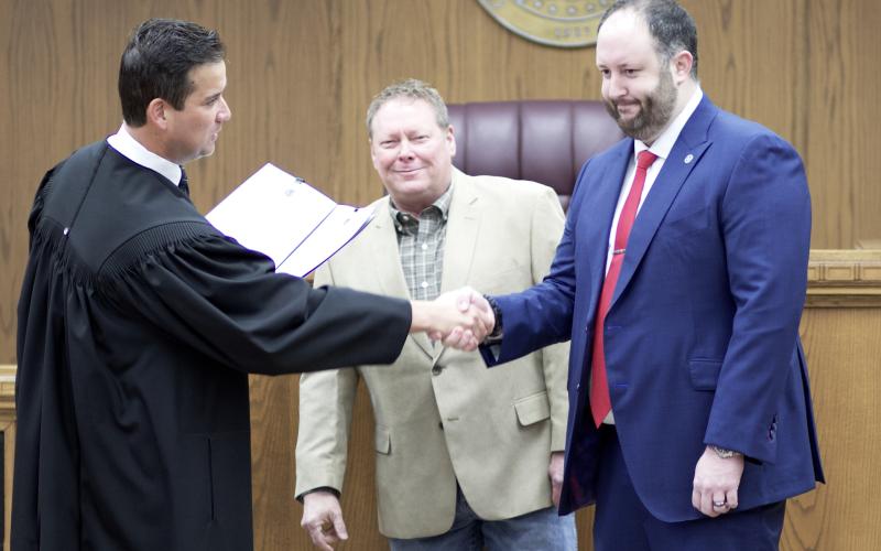 From the left, District Judge Grant Sheperd administers the oath of office to commissioners John O’Brien and Josh Powers Dec. 30, 2022, in the jury room on the second floor of the courthouse. O’Brien and Powers pledged to support the U.S. Constitution, the Oklahoma Constitution and federal and state laws. CARL LEWIS | SOUTHWEST CHRONICLE