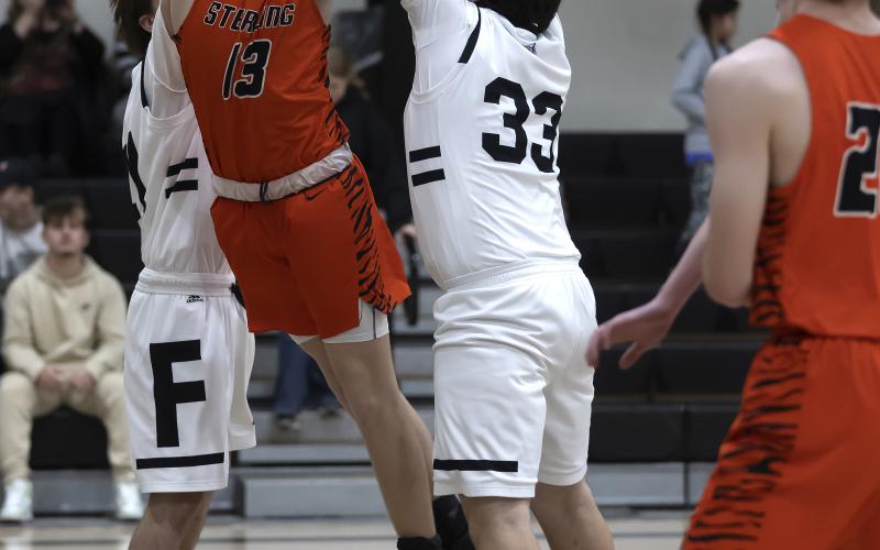Riley Lile (13) shoots an off-balanced shot against Fletcher Tuesday night. Lile finished with six points in the Sterling win. HUGH SCOTT JR. | SOUTHWEST CHRONICLE