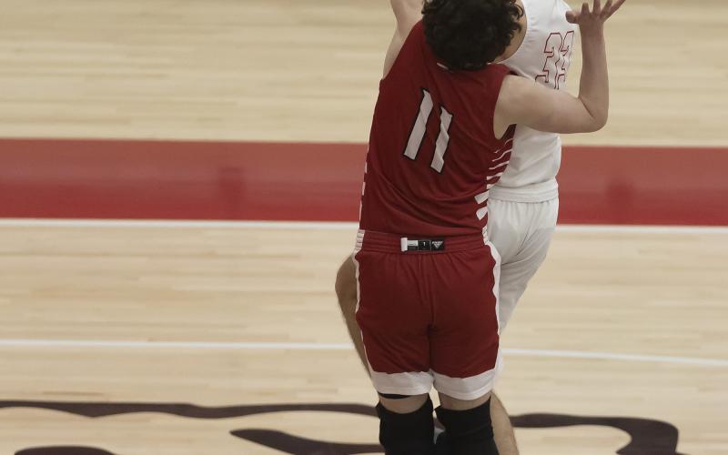 Elgin senior Christian Reed shoots the ball over the outstretched hands of a Plainview defender during the Purcell Tournament. Elgin lost to Tuttle last Friday but will try to get back on the winning track Feb. 3 at Bethany. HUGH SCOTT JR. | SOUTHWEST CHRONICLE
