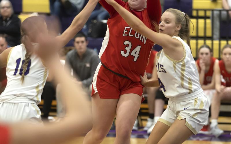 Freshman post player Danika Pendley passes the ball to a teammate despite being swarmed by Community Christian defenders. HUGH SCOTT JR. | SOUTHWEST CHRONICLE