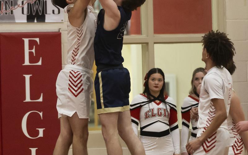 Owl defender Christian Reed, left, tries to a block a shot from a Kingfisher player during last Friday’s game. HUGH SCOTT JR. | SOUTHWEST CHRONICLE