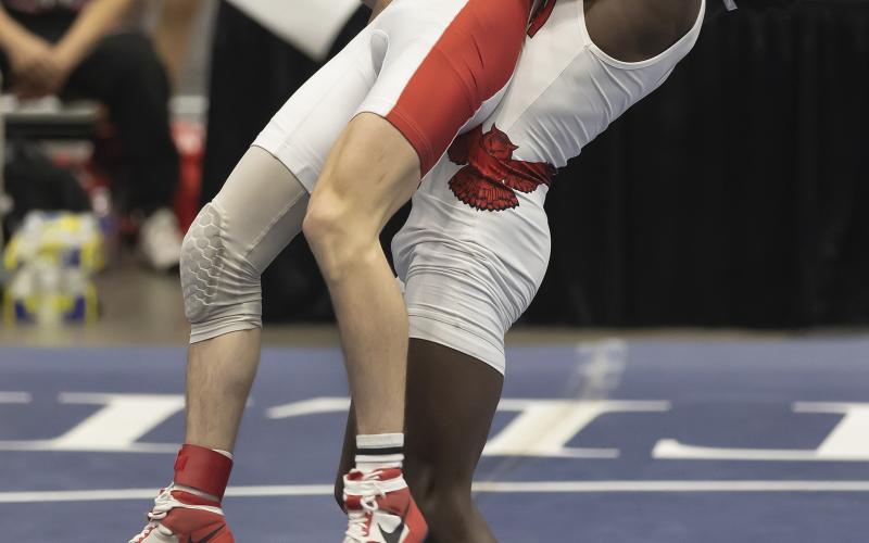 Owl grappler Brice Martin, right, lifts his opponent during semifinal action Saturday. Martin won his match by fall. HUGH SCOTT JR. | SOUTHWEST CHRONICLE