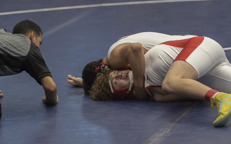 Owl grappler Jonavin Mullins, (top) is about to pin his opponent during Elgin’s semifinal dual. Mullins pinned his opponent in the 175-pound match at 1:43 of the second period. HUGH SCOTT JR. | SOUTHWEST CHRONICLE