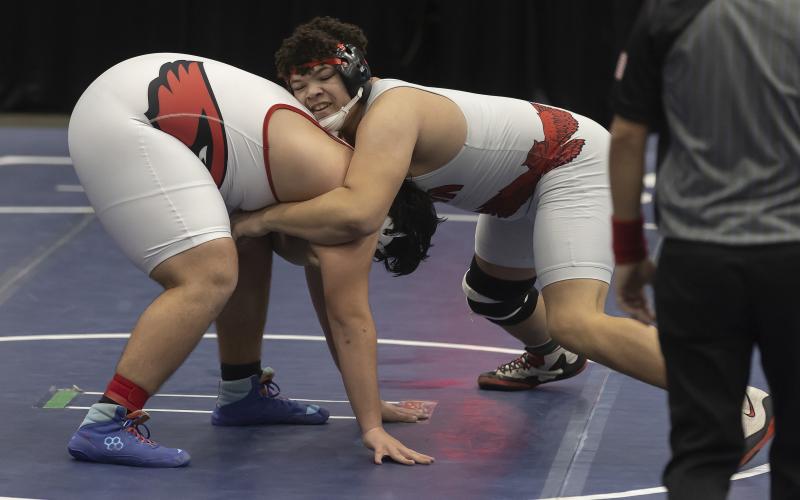 Elgin heavyweight Shea Spencer, right, gains control of his opponent and later earns a 5-2 win to boost the Owls into an early team lead. HUGH SCOTT JR. | SOUTHWEST CHRONICLE