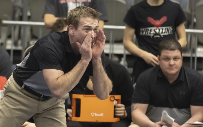 Elgin head coach Cody Rowell yells instructions to an Owl wrestler during the Dual State competition. Elgin won the Dual State title with a convincing win over No. 2 ranked Coweta. HUGH SCOTT JR. | SOUTHWEST CHRONICLE