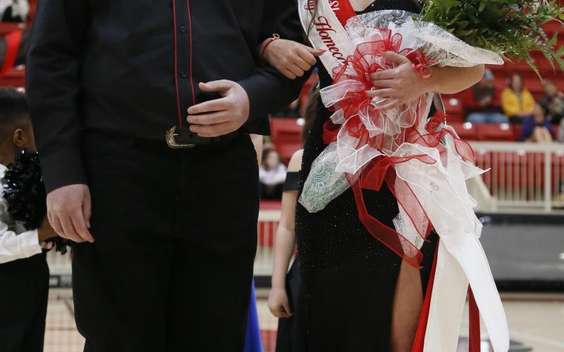 Spring homecoming Queen Mikayla Arnold, right, smiles to the crowd after being crowned Tuesday night. At her left is homecoming King Hunter McDonald. The ceremony occurred before the start of the girls varsity basketball game. Arnold represented Elgin’s slow-pitch softball team. RIP STELL | SOUTHWEST CHRONICLE