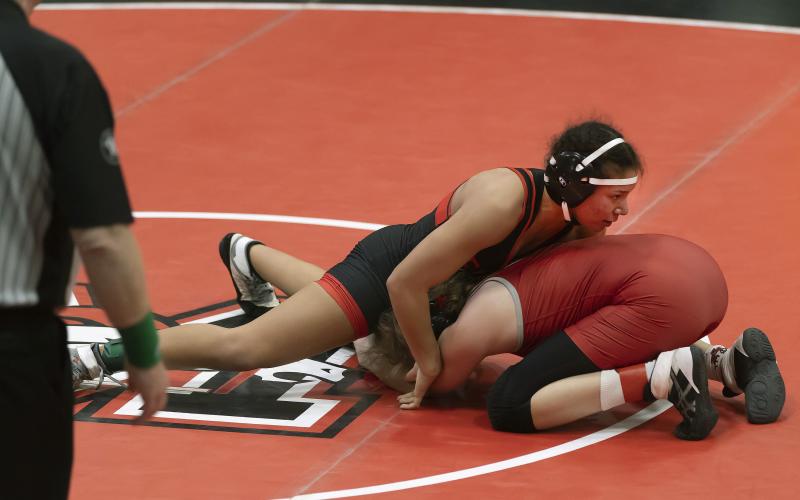 Junior Symphony Veloz works to pin her opponent in the first-place match of the 170-pound weight class at the 6A West Regional tournament. Veloz won by fall and took home the regional championship. She will compete in this week’s state tournament. HUGH SCOTT JR. | SOUTHWEST CHRONICLE