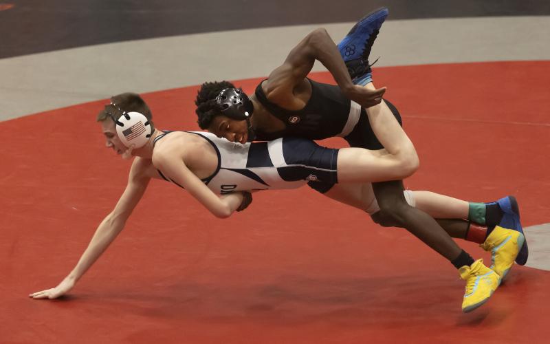 Brice Martin, top, slams El Reno’s Foxx Kurtz to the mat in the third-place match last Saturday during regional tournament action. Kurtz defeated Martin 5-2. However, Martin qualified for the state tournament with his fourth-place finish. HUGH SCOTT JR. | SOUTHWEST CHRONICLE