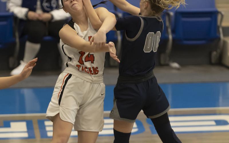 Lady Tiger Ashlyn Clift (14) is smacked in the face after passing the ball to a teammate during regional tournament action against Cordell. HUGH SCOTT JR. | SOUTHWEST CHRONICLE