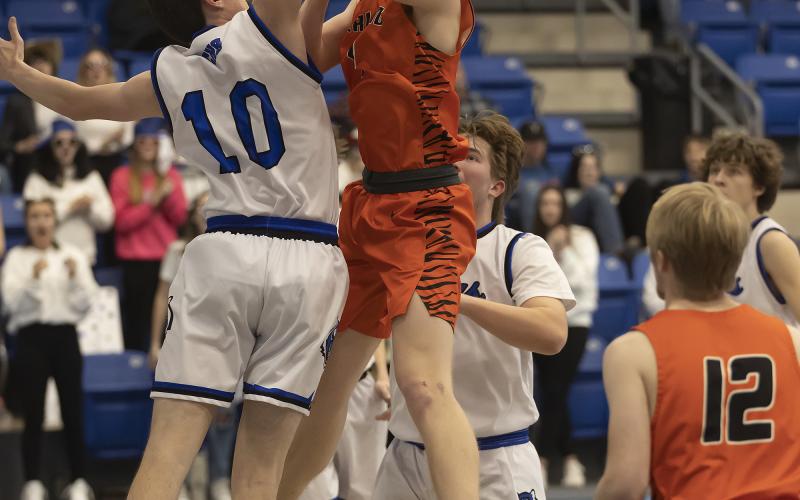 Sterling senior Hayden Taliaferro attempts a shot around the arm of a Union City defender during Class A regional tournament action last week. Union City defeated Sterling and knocked the Tigers out of the playoffs. HUGH SCOTT JR. | SOUTHWEST CHRONICLE