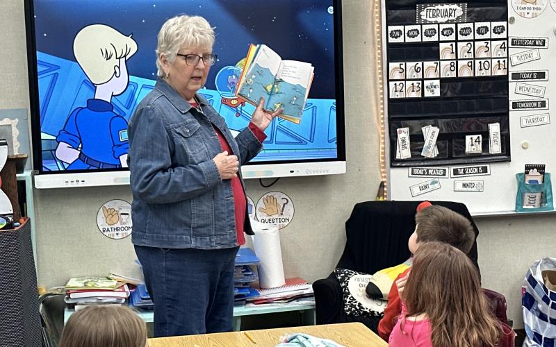 Fletcher first grade students from Ms. Dusty Strange and Mrs. Jamie White’s classes celebrate Read Across America Day as Friends of Elgin Community Library member Debbie Thomason, who also chairs the Dr. Seuss committee, reads “What Pet Should I Get?” Read Across America annually honors the world-renowned children’s author and illustrator Dr. Seuss on his birthday, March 2. DUSTY STRANGE AND JAMIE WHITE