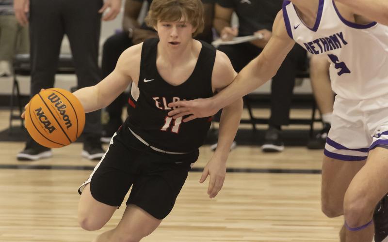 Elgin junior Denton Glover (11) dribbles into the lane during regional tournament action last week. The Owls won the regional tournament to advance to the Area Tournament this week in Hennessey. HUGH SCOTT JR. | SOUTHWEST CHRONICLE