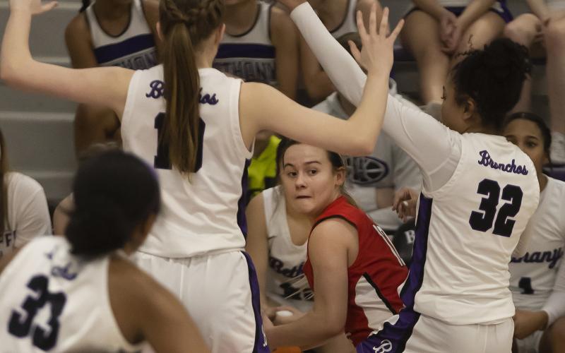 Point guard Maycee Hill looks under the arms of  two Bethany defenders as she tries to find an open teammate during Elgin’s loss to the Lady Bronchos last week. HUGH SCOTT JR | SOUTHWEST CHRONICLE