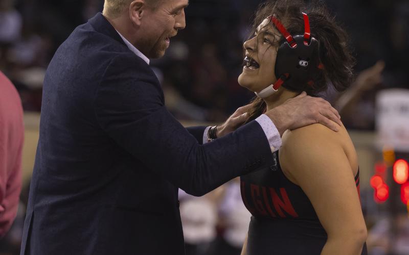 Two-time state champion Symphony Veloz is congratulated by her coach, Cody Rowell, after she won the Class 6A state title at 170 pounds. HUGH SCOTT JR. | SOUTHWEST CHRONICLE