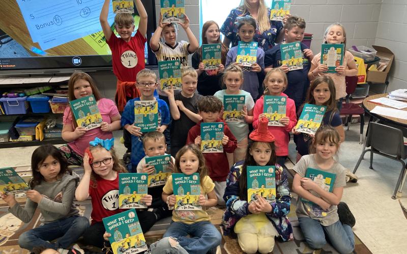 Fletcher first grade students from Ms. Dusty Strange and Mrs. Jamie White’s classes celebrate Read Across America Day as Friends of Elgin Community Library member Debbie Thomason, who also chairs the Dr. Seuss committee, reads “What Pet Should I Get?” Read Across America annually honors the world-renowned children’s author and illustrator Dr. Seuss on his birthday, March 2. DUSTY STRANGE AND JAMIE WHITE