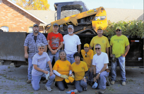  A group of ten Southern Baptist Disaster Relief volunteers take a quick break to pose for a group photo after cleaning up four yards