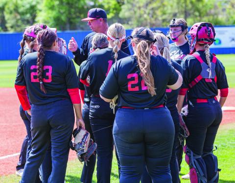 HUDDLE: Elgin's Lady Owls receive final instructions before starting their Regional softball tournament in Choctaw.  SW Chronicle photo by Rick Endicott