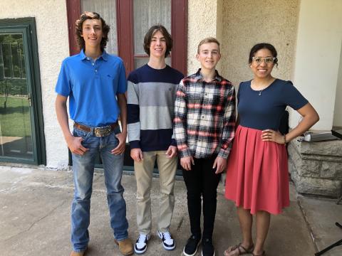 From left are essay contestants Chase Pickett (2nd place), Gideon Gish (1st place), Ben Schulke (3rd place) and Ashley Chapman, vice president of The Red Cord. Pickett and Gish are homeschooled students from Lawton and Schulke will be a senior at Elgin High School.  Photo by Tim Farley