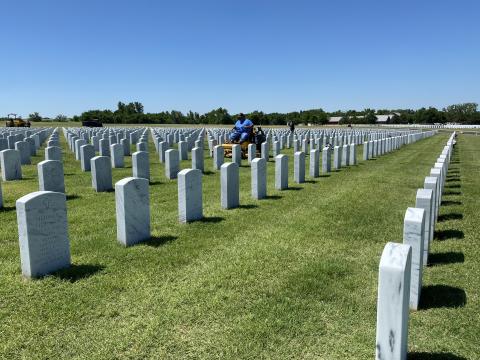 Pablo Lopez Jr., foreman for Byrd Enterprises, mows the grounds of Fort Sill National Cemetery in preperation for Memorial Day. SW Chonicle Photo by Curtis Awbrey