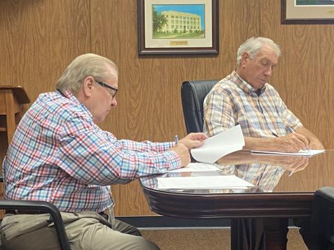 From the left, Comanche County Commissioners Johnny Owens and Gail Turner sign documents Monday at the Comanche County Courthouse. The commission voted 3-0 to earmark $1.3 million in American Rescue Plan Act dollars for each of the county’s three districts.  Eric Swanson/Staff photo