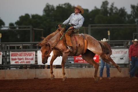 Garrett Tucker, of Elgin, competes in the first round of bronc riding at the Chickasha Open Rodeo held June 24-25 at the Grady County Fairgrounds. Tucker finished third in the competition.  (Photo by Hugh Scott)