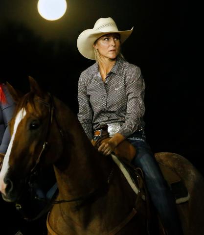 With a full moon rising over the event Barrel Racer Savannah Woodfin waits her turn at the rodeo. RIP STELL PHOTOS