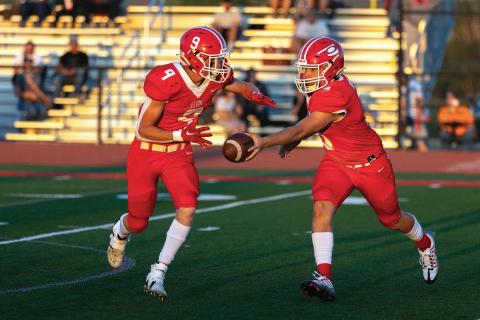 Elgin quarterback Tres Lorah (3) hands the ball to junior tailback Matthew Lund during first half action against Weatherford last Friday. Photo by Hugh Scott Jr.