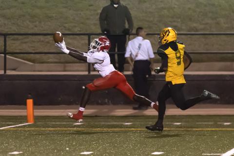 Junior wide receiver Michael Adesola (4) stretches for the winning TD catch in Elgin's come-from-behind 20-13 win over Lawton MacArthur Thursday night at Cameron Stadium. (Photo by Hugh Scott Jr.)