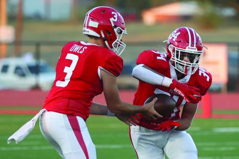 Elgin quarterback Tres Lorah (3) hands the ball off to running back Ritson Meyer during Friday's 35-0 win over Ardmore. (Photo by Hugh Scott Jr.)