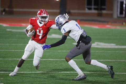 Elgin wide receiver Michael Adesola (4) tries to avoid a tackle by a Guthrie defender during Friday's playoff game. Adesola caught three passes for 26 yards in Elgin's 17-0 loss. (Photo by Hugh Scott Jr.)