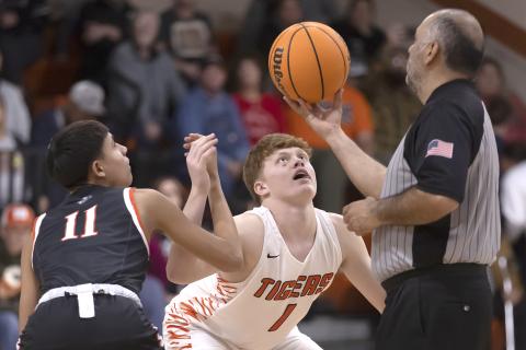 Hugh Scott Jr. | Southwest Chronicle Sterling’s Hayden Taliaferro (1) keeps a close eye on the ball as he prepares to tip off the first quarter of the Dec. 16 game with Apache. Apache defeated the Tigers 66-46 as Sterling dropped to 6-6 for the season.