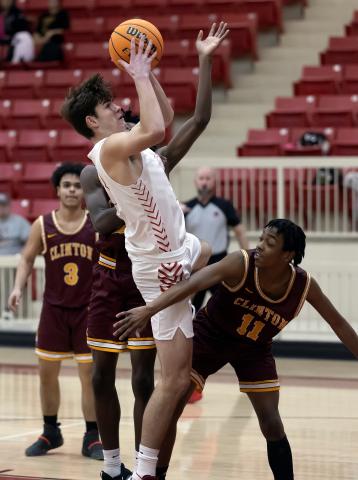 Owl forward Christian Reed (33) takes a shot during Tuesday’s win over Clinton. Reed tallied 15 points in the matchup. HUGH SCOTT JR. | SOUTHWEST CHRONICLE