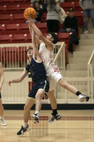 Elgin’s Tommy Glover, right, battles for the ball with a Kingfisher defender during last Friday’s Western Conference matchup. Kingfisher defeated the Owls 55-27. HUGH SCOTT JR. | SOUTHWEST CHRONICLE